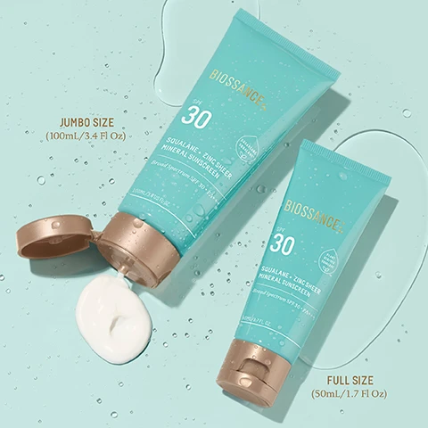 Image 1 - Two tubes of Biossance Squalane Zinc Sheer Mineral Sunscreen are displayed against a light blue background, one tube is open with white sunscreen oozing out, and the visible text includes JUMBO SIZE (100mL/3.4 Fl Oz) and FULL SIZE (50mL/1.7 Fl Oz) along with SPF 30 and Broad Spectrum SPF 30 PA++.
Image 2 - A turquoise sunscreen tube with a gold cap is shown on a light background, with water droplets on its surface and text listing benefits such as invisibly blocks rays, weightlessly hydrates, prevents inflammation, blocks daytime aggressors, prevents blue light damage, and saves skin from pollutants.
Image 3 - Image features a diagram labeled Multi-Defense Meets Melt-In Texture, displaying elements that block harmful rays and deliver hydration, with various items listed under BLOCKS and DELIVERS, and includes sun and skin layer illustrations.
Image 4 - A close-up view of a smooth, creamy lotion spread on a surface, with visible text that reads lightweight lotion with untraceable, oil-free finish.